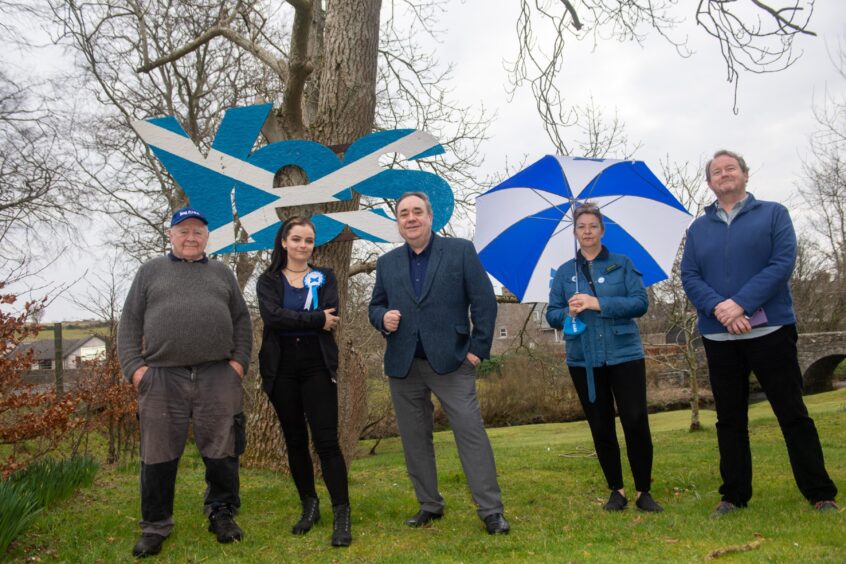 Mr Salmond pictured with Mike Morgan Charlotte Cross, Alex Salmond, Trish McPherson and Andy McCall in front of a Yes independence sign in the grounds of his Strichen home.