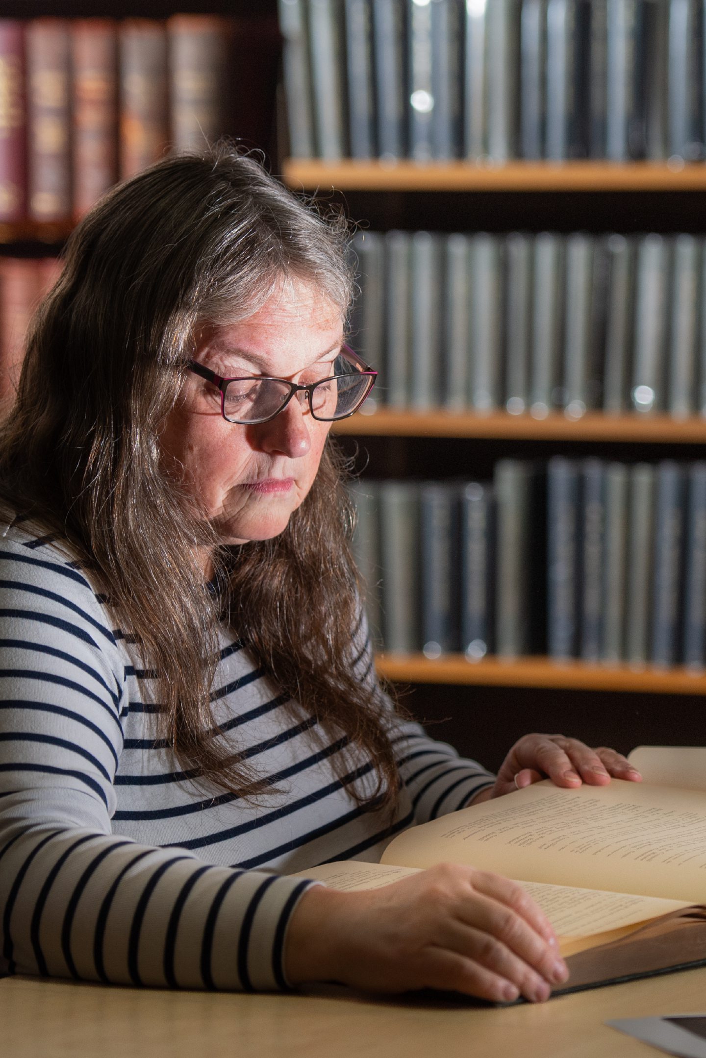 Historian and researcher Dr Alison McCall looks at a book at Central Library Aberdeen.