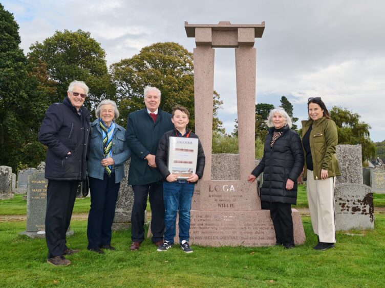 Members of the Logan family at Willie Logan's headstone 