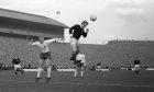 Scotland's Denis Law wins the ball ahead of England's Bobby Moore. Also pictured for England in the background (c) is Bobby Charlton.