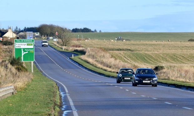 Traffic travelling southbound on the A90 with fields on both sides.