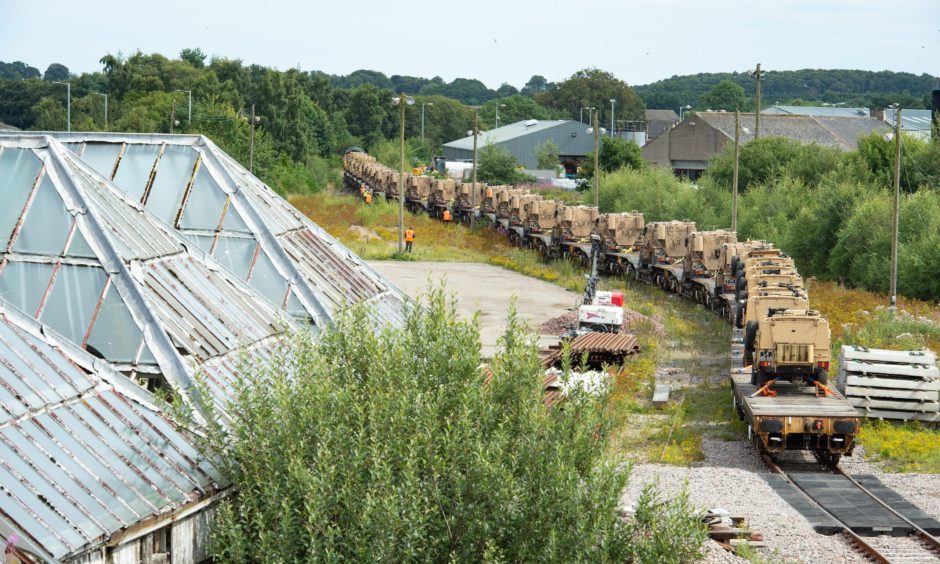 Army convoy at Elgin freight yard. 