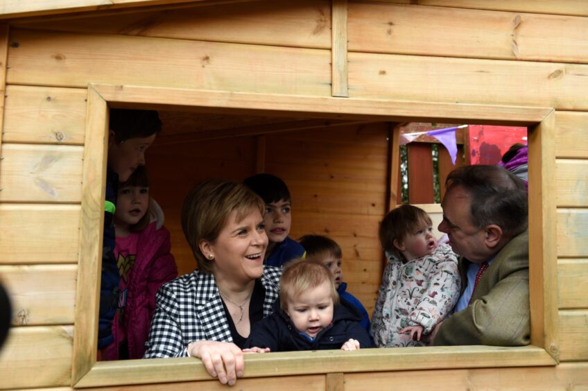 Nicola Sturgeon holding 9 month old Alastair Ruddick as Mr Salmond held 5 month old Roslyn Rankine during a visit to Dreams Daycare nursery in Insch in 2017. 