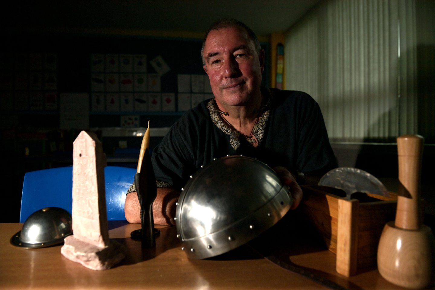 Dr Andrew Newton in his Pictish tunic, surrounded by reproduction objects of the period.