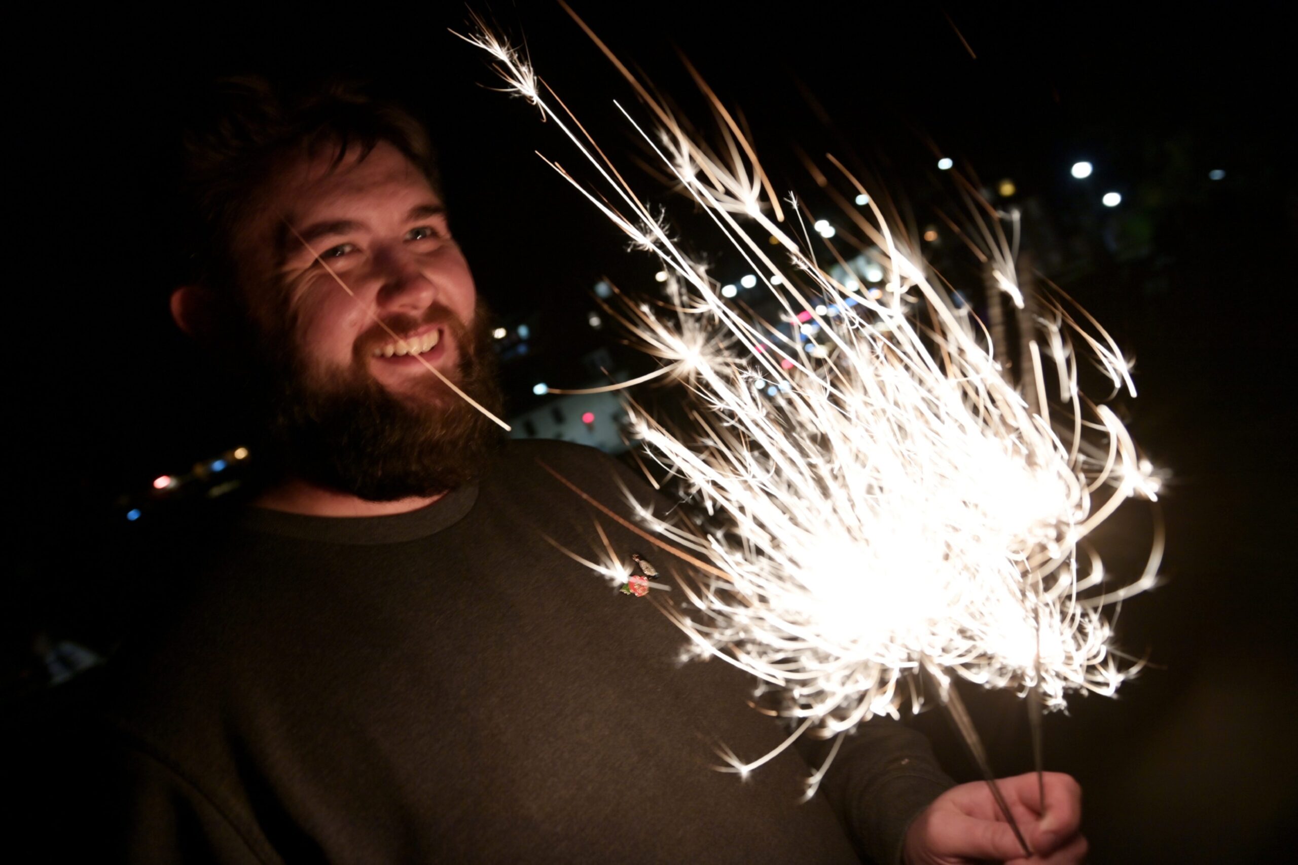 Man smiling with a sparkler