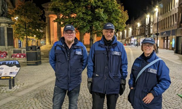 Three street pastors on Elgin High Street.