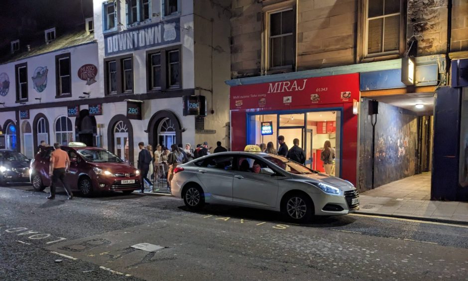 Taxis outside Elgin takeaway. 