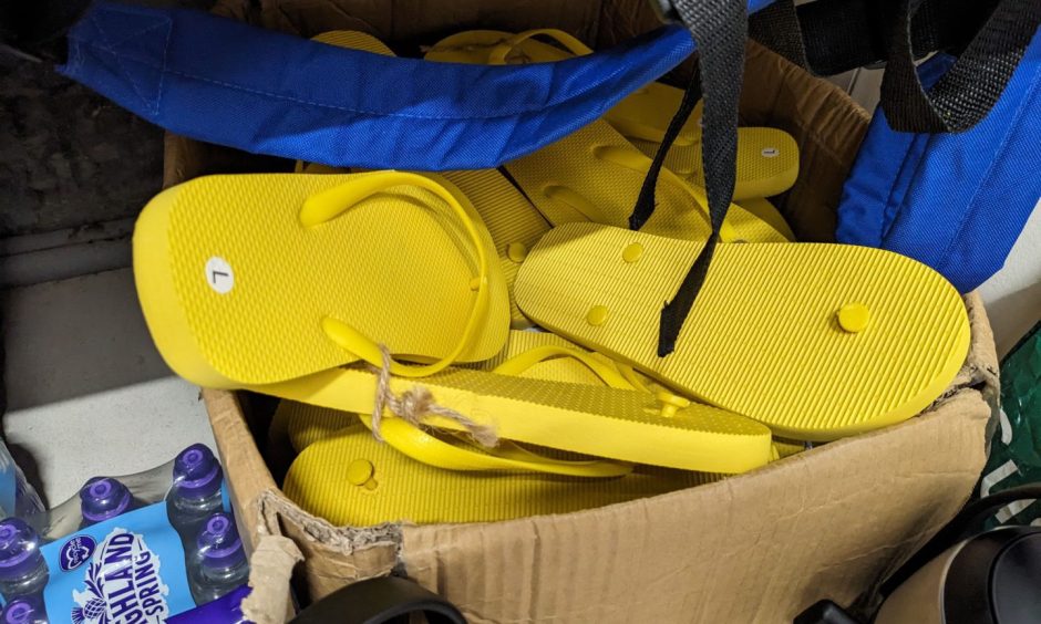 Box full of yellow flipflops. 