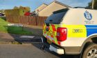 Police vehicle on residential street Craigard Terrace in Kinmylies areas of Inverness.