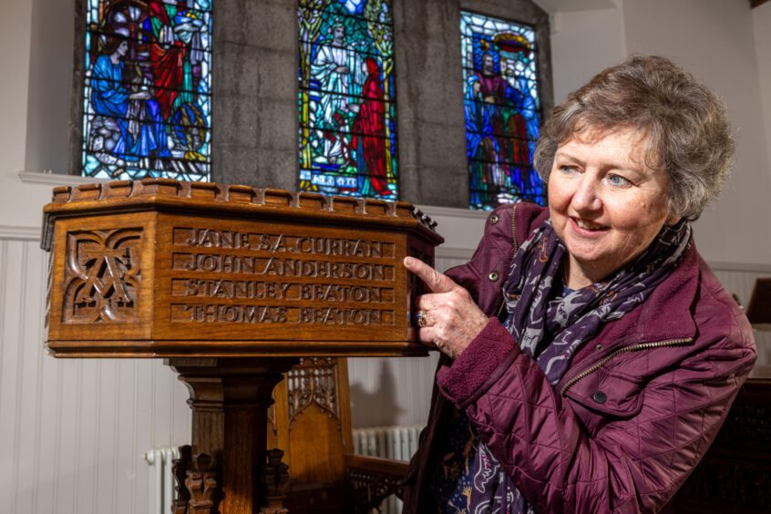 Pat Boyd, a former doctor and elder of Fountainhall Church, with Jane's memorial font. 