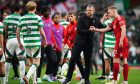 Aberdeen manager Jimmy Thelin (centre right) shake hands with Aberdeen's Gavin Molloy (right) after the final whistle at Celtic Park. Image: Shutterstock.