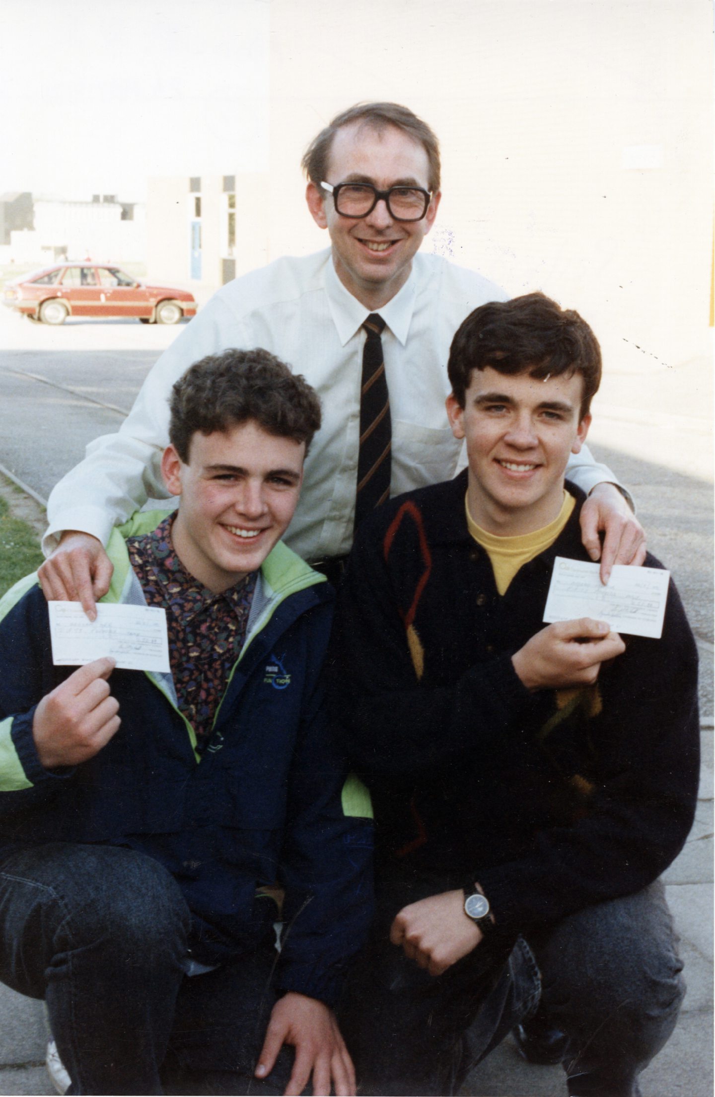 West Don Community Council chairman Gordon Selby presents Dyce boys 17-year-old Graham Orr and Andrew Moncur, 16, with £50 each to help them reach the £2,000 they had to raise to take part in the 1992 Cutty Sark Tall Ships race.