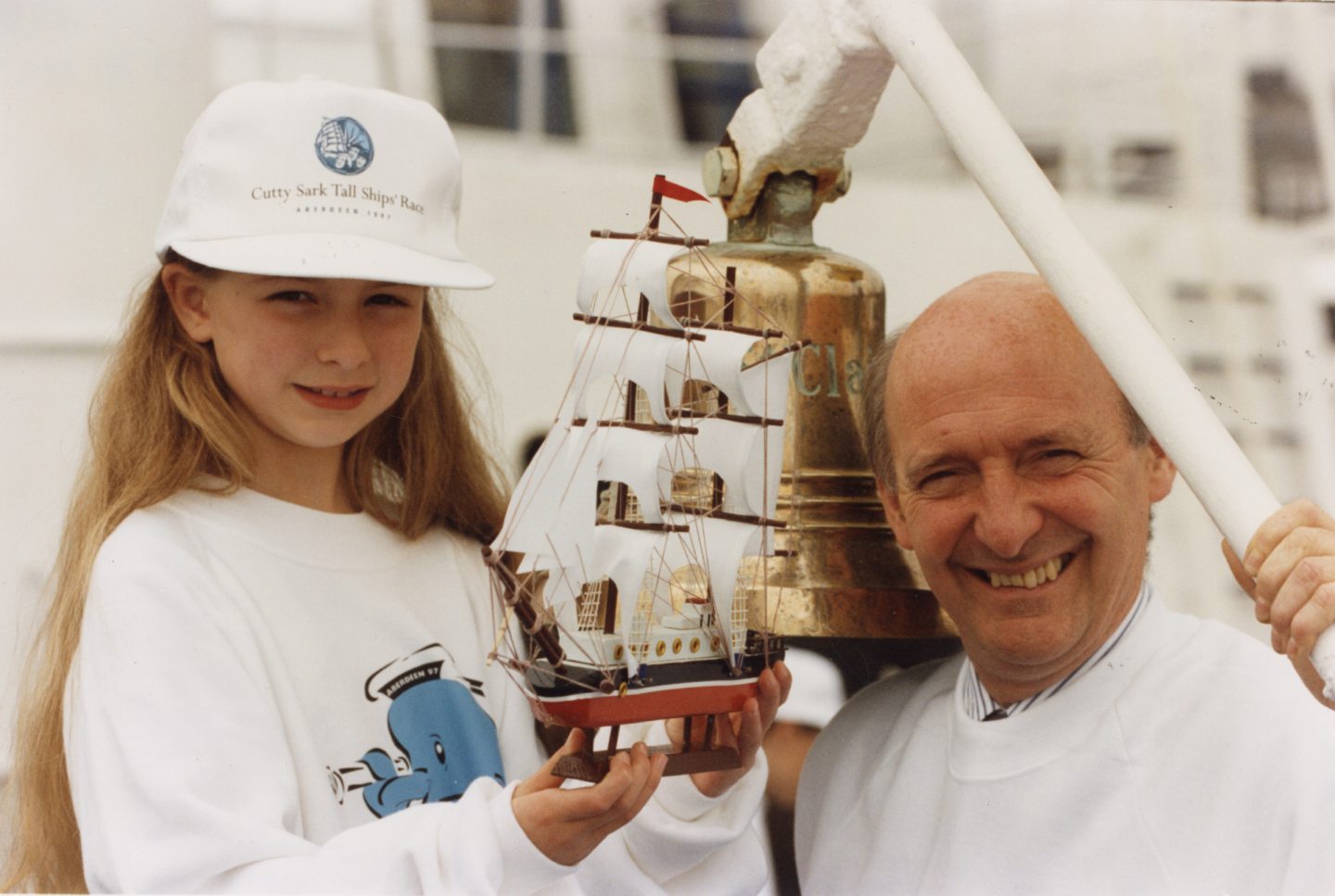 John Ling shows eight-year-old Kate Barnard a model of a tall ship