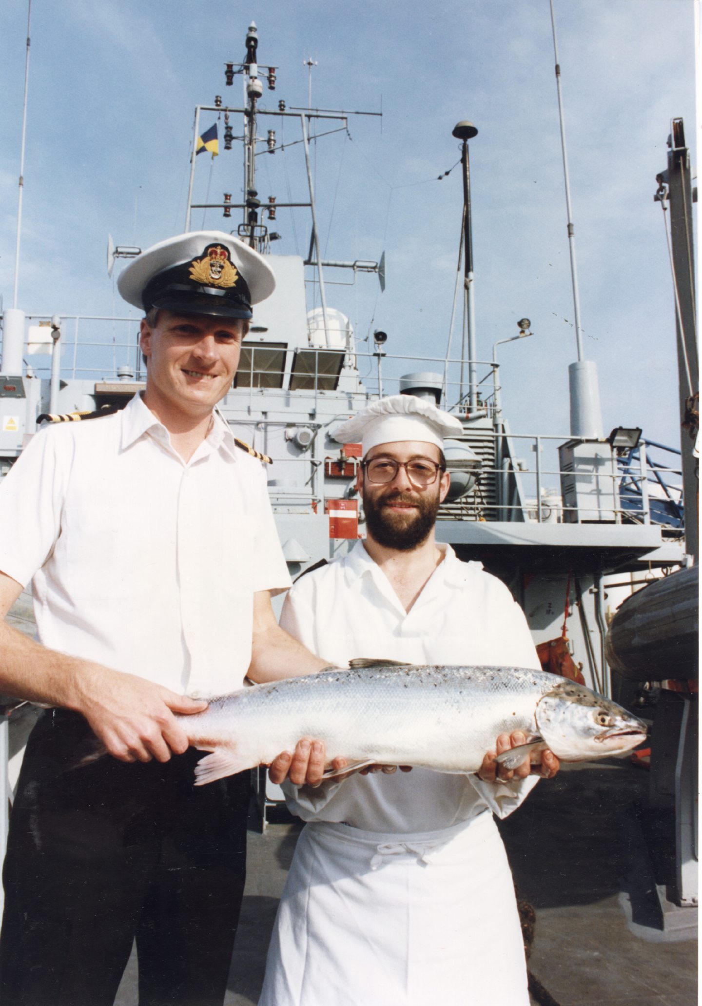 Two men holding a fish