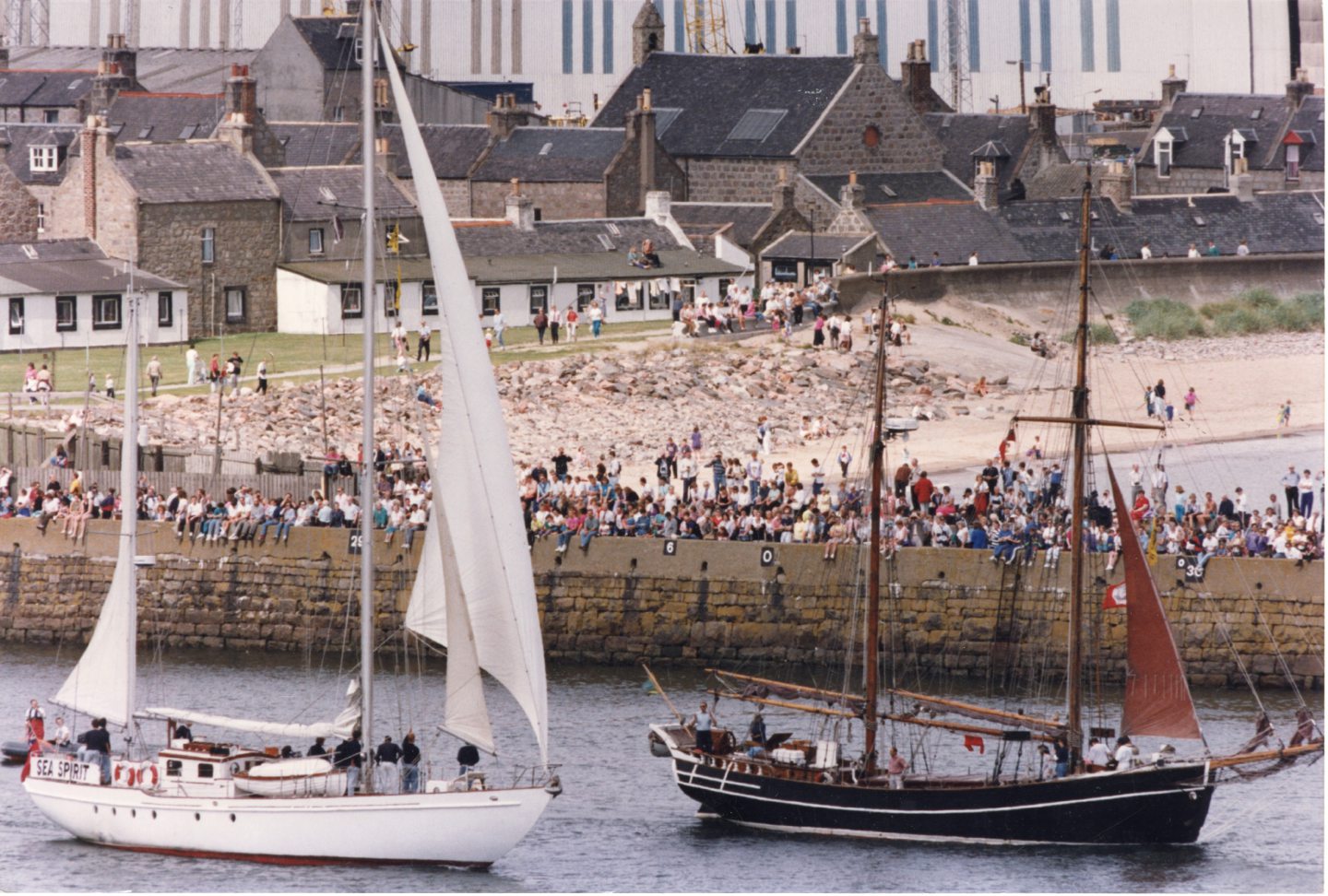 The Gordonstoun School vessel Sea Spirit, left, and the Carola Travemund, from Germany, passing the crowded North Breakwater.