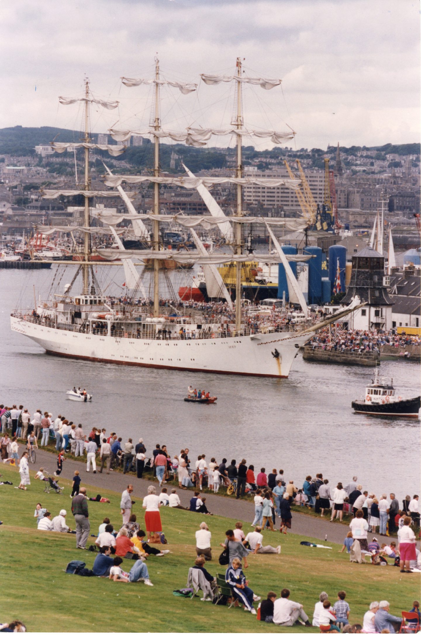 Crowds of sightseers at Balnagask Golf Course bid farewell to the Russian vessel Mir as it passes the Round House at Aberdeen harbour with the pilot boat and two small pleasure craft in close attendance