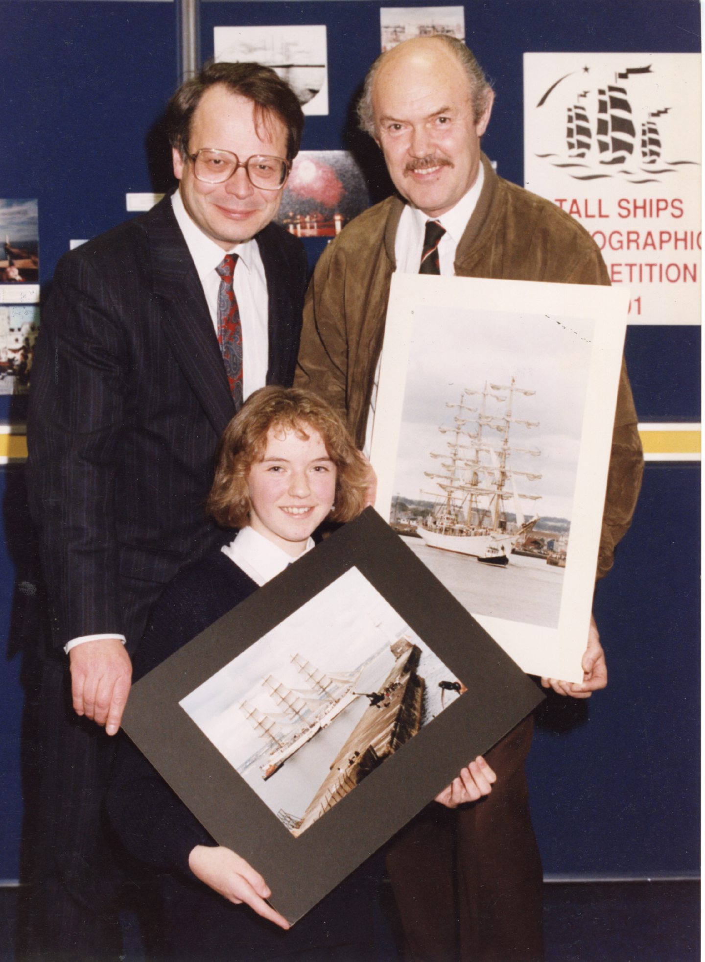 Winners holding their entries in the Aberdeen Libraries tall ships photographic competition