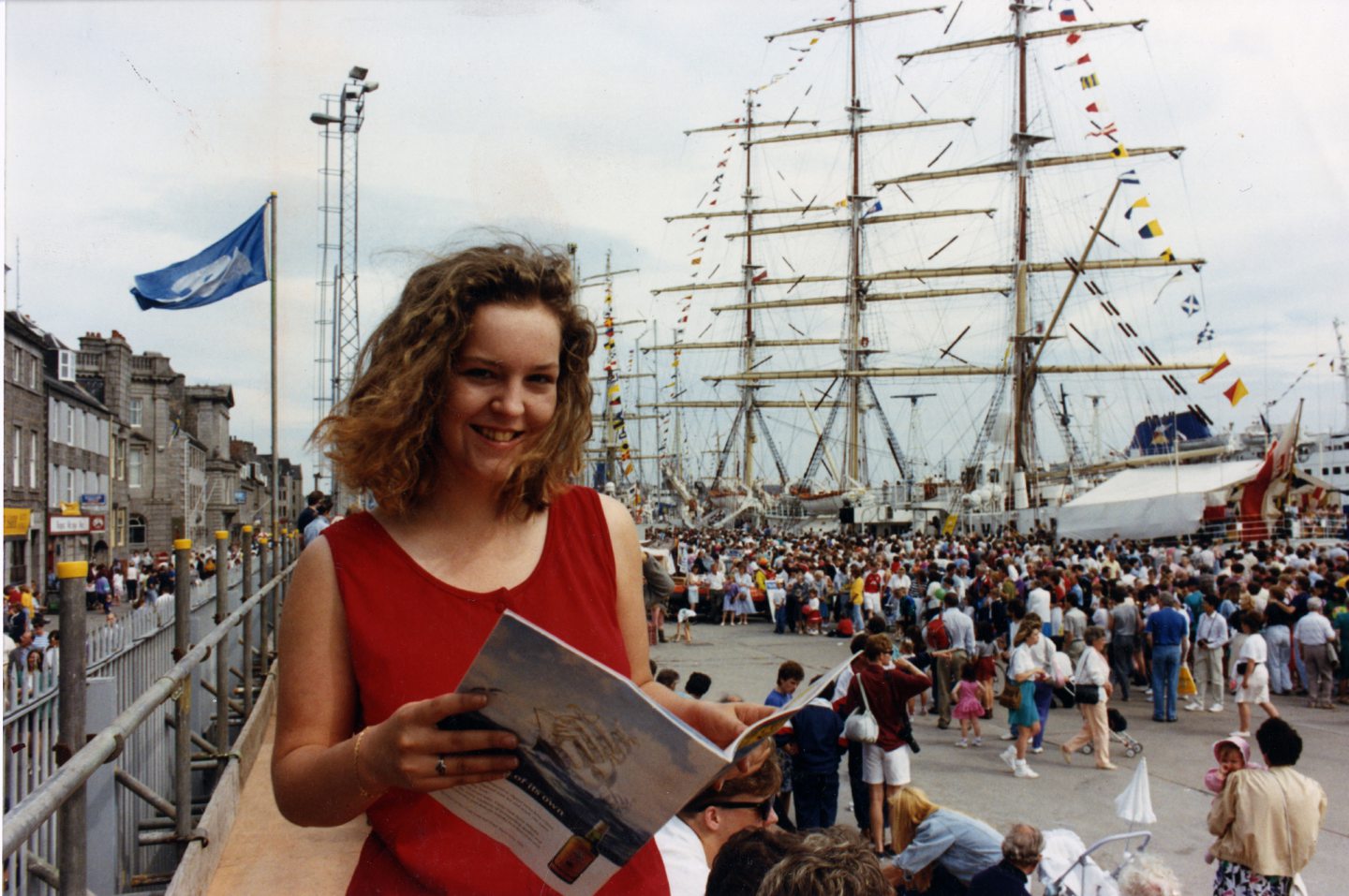 Kelly Webster takes a break in the sunshine to read up on the Tall Ships in the event programme