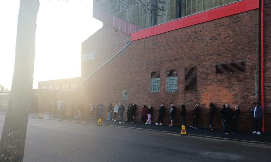 Aberdeen FC supporters queue outside stadium.