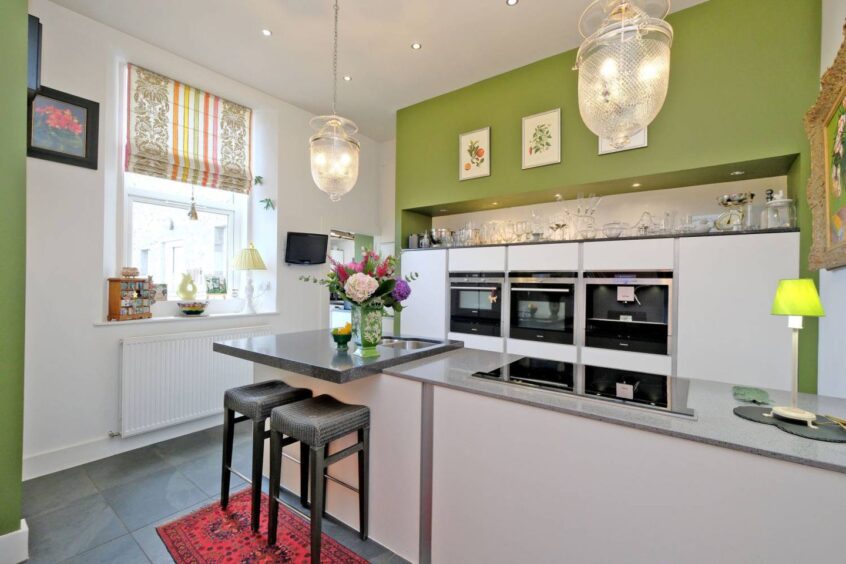 The kitchen enjoys a large breakfast bar. 