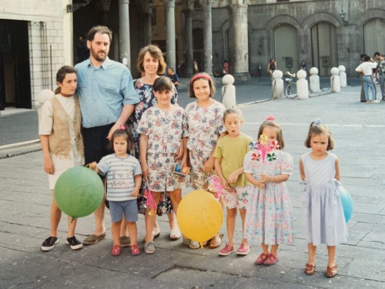 Flora and Rosie as children alongside their parents, three other sisters and two cousins, near Barga, Italy.