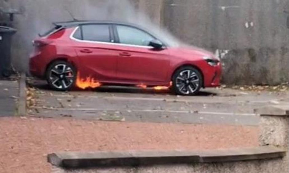 Red Vauxhall Corsa Electric on fire in Bucksburn, Aberdeen.