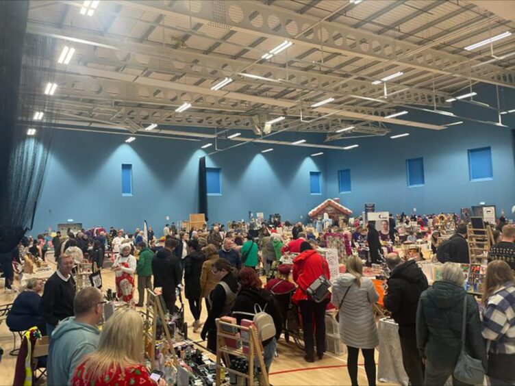 Dozens of people and stalls at the Elgin Christmas market.