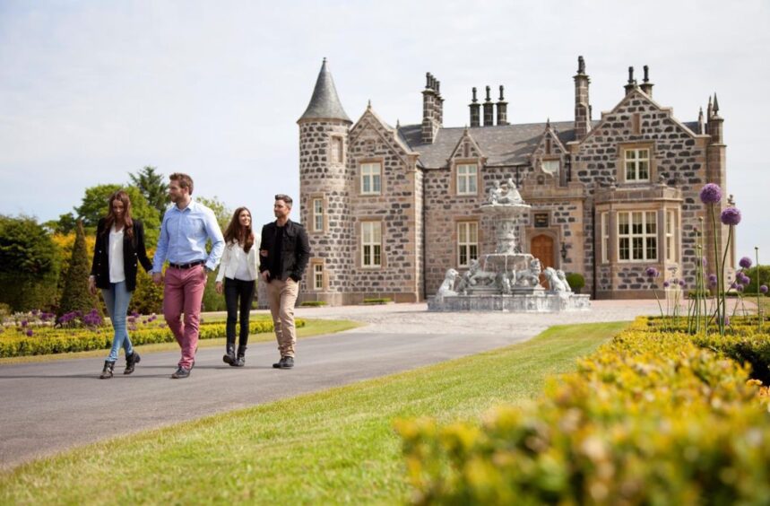 People walking away from a castle.