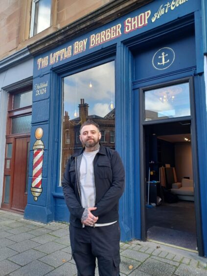 Mark Andrew outside his traditional barber shop in Oban