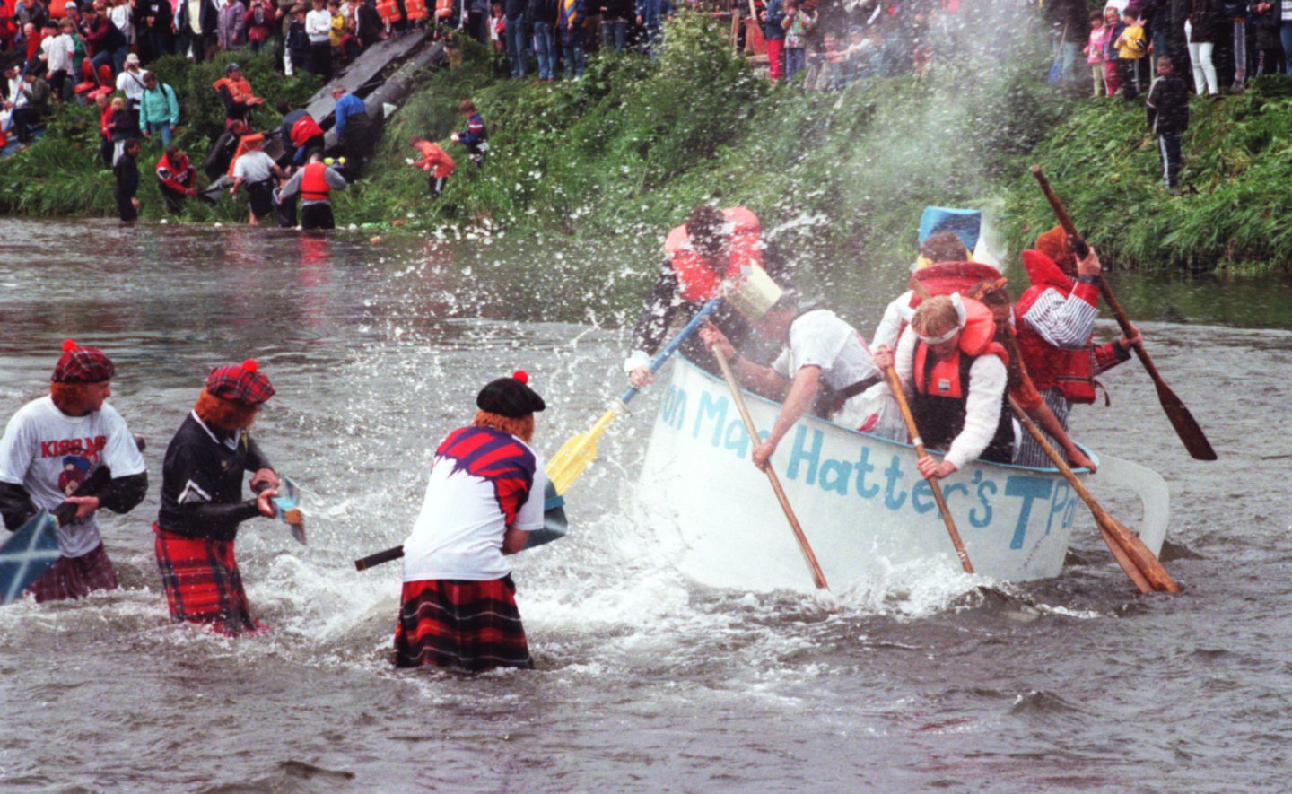 People in kilts and fancy dress splashing in and out of the water at the YTHAN RAFT RACE 1998The Mad Hatters get a soaking as they start off down the Ythan on Saturday.