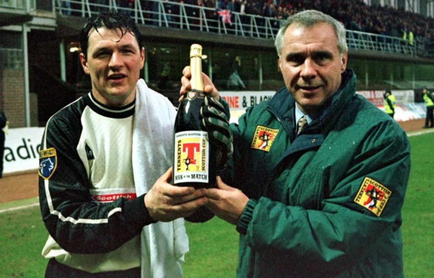 Goalkeeper Jim Calder accepts his man of the match award from Bob Smith, of sponsors Tennents, after playing in the 3-0 Scottish Cup defeat against Rangers at Tannadice in 1996.