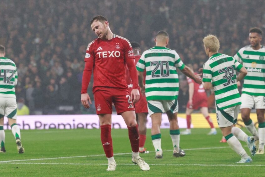 Nicky Devlin was left dejected as the Dons' League Cup hopes were ended by Celtic at Hampden. Image: Shutterstock