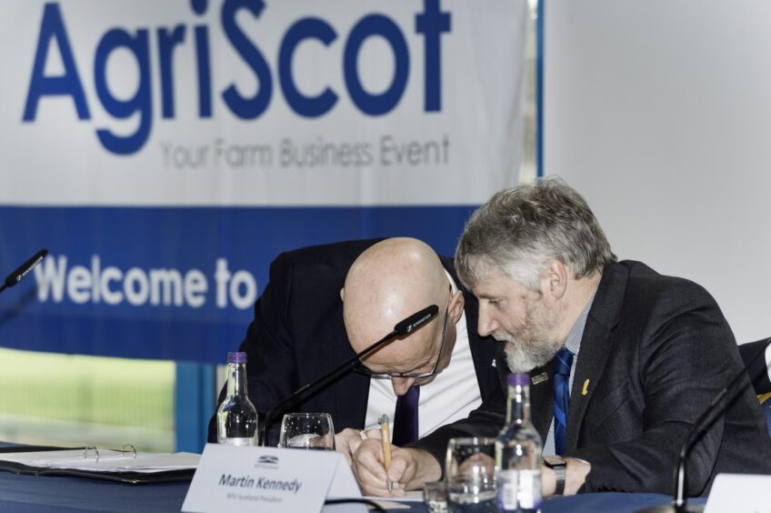 First Minister John Swinney, left, and NFUS president Martin Kennedy take notes at AgriScot.