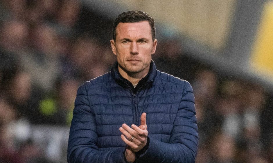 Ross County manager Don Cowie applauds his team from the sidelines. 