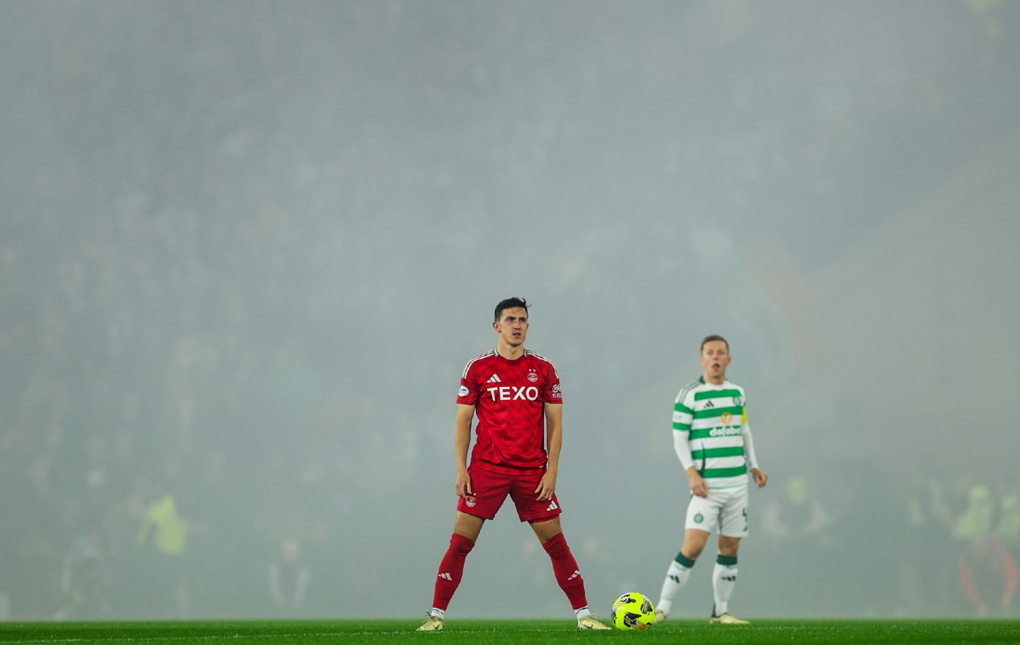 Aberdeen's Jamie McGrath waits as kick off is delayed due to poor visibility after pyros were let off at Hampden. Image: SNS