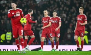 Aberdeen's Topi Keskinen (centre) looks dejected during the match against Celtic. Image: SNS.