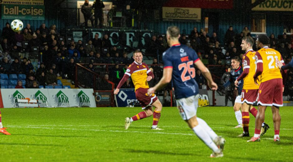 Motherwell and Ross County players watch as the ball flies through the air and Josh Nisbet scores to make it 2-0 to the Staggies