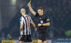 Referee John Beaton shows a yellow card to St Mirren's Alex Gogic during a match against Aberdeen. Image: SNS.