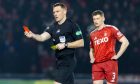 Referee John Beaton reduces Alex Gogic's red card to a yellow after a VAR check. Image: SNS.