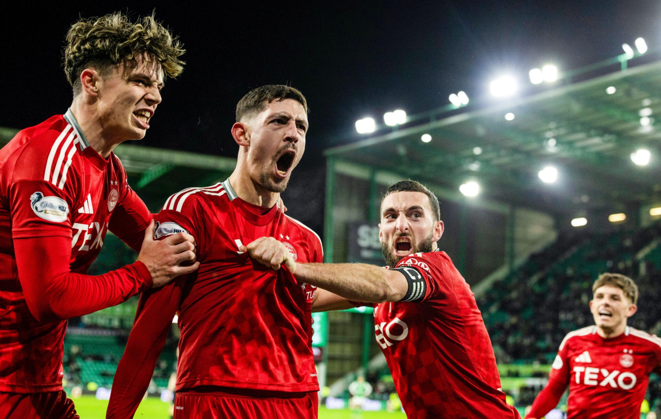 Aberdeen's Ester Sokler (centre) celebrates after scoring to make it 3-2 against Hibs with Graeme Shinnie and Jack Milne. Image: SNS 