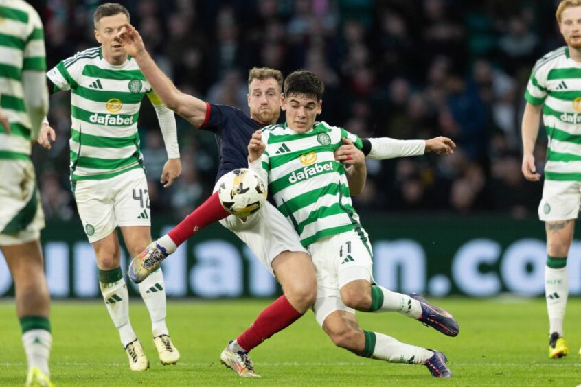 Ross County's Jordan White challenges Celtic's Alex Valle in the Dingwall team's 6-0 Premiership defeat on November 30, 2024. 