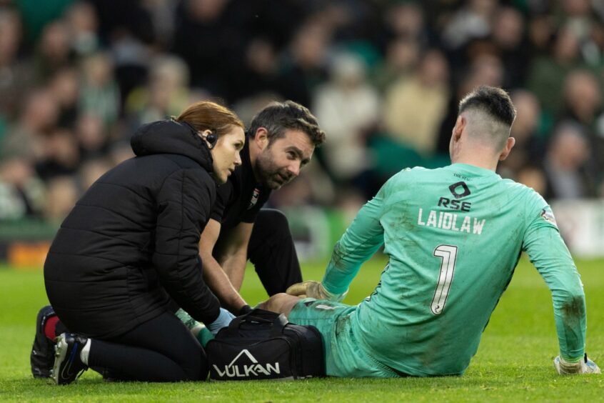 Ross County goalkeeper Ross Laidlaw receiving treatment from the medics for his knee injury against Celtic on Saturday, November 30, 2024.