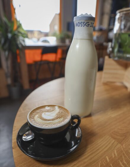 The costly flat white with a bottle of Mossgiel Farm milk.