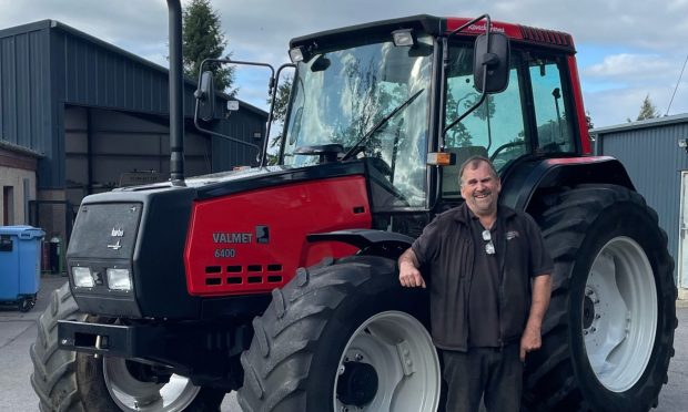 Ali Young with a tractor he's restored.