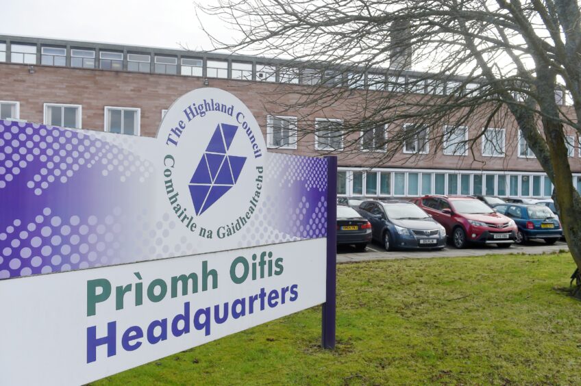 Purple and white sign showing the Highland council logo outside their headquarters in Inverness.