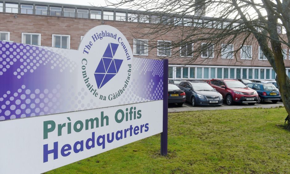 Purple and white sign showing the Highland council logo outside their headquarters in Inverness.