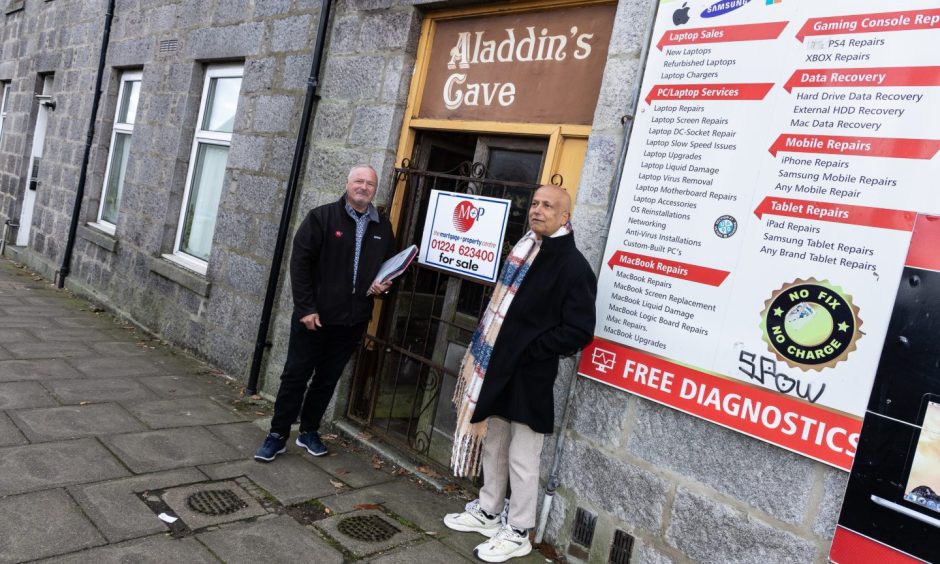 Image shows viewing agent George Sharp and Masood Hussain outside Aladdin's Cave, Aberdeen.