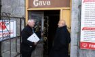 Image shows viewing agent George Sharp and Masood Hussain outside Aladdin's Cave, Aberdeen.