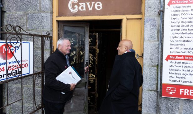 Image shows viewing agent George Sharp and Masood Hussain outside Aladdin's Cave, Aberdeen.