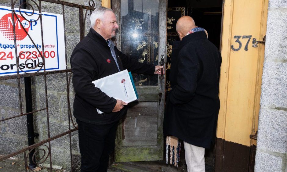 Image shows viewing agent George Sharp and Masood Hussain outside Aladdin's Cave, Aberdeen.